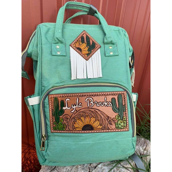 diamond-shaped leather patch is on your backpack Diaper backpack with Custom patches & Fringe on upper patch